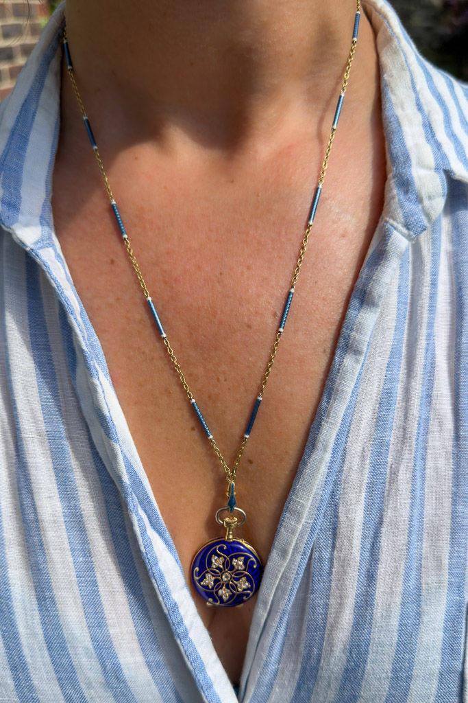 Model wearing the antique 18ct gold watch chain with blue guilloché enamel bar links.