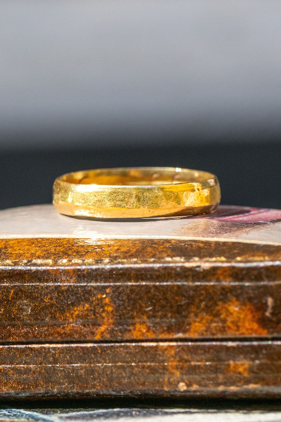 Thumbnail: A side view of the subtly hammered texture on the outside of the 22ct gold posy ring