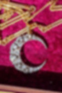 Antique old cut diamond crescent brooch with removable brooch fitting displayed alongside an antique gold trombone link chain