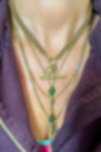 Neck shot of the Victorian 15ct gold ball-and-chain collar worn with the bolt ring and charms positioned at the front