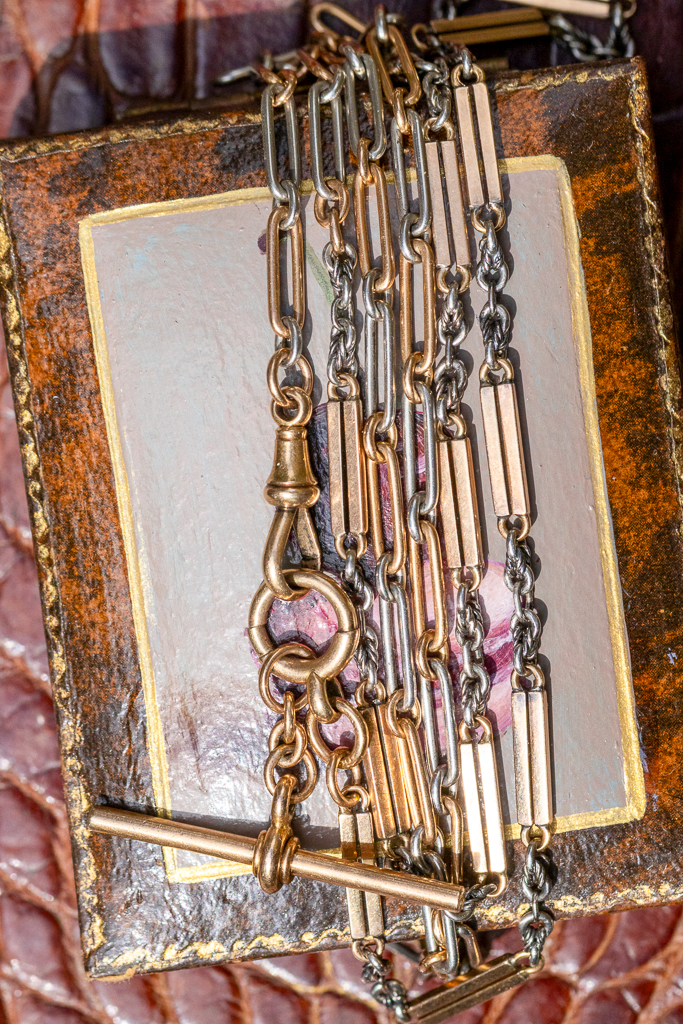 Antique high carat mixed link watch chain with paperclip, oval, flat bar and knot links in warm gold and platinum tones.