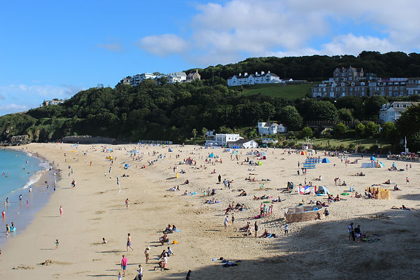 Porthminster beach, Porthminster, beach cafe, family friendly, calm seas, paddleboarding, putting green, lifeguard, golden sands, toilets, refreshments, St Ives railway, beach huts, turquoise sea, blue flag beach, paddling, swimming