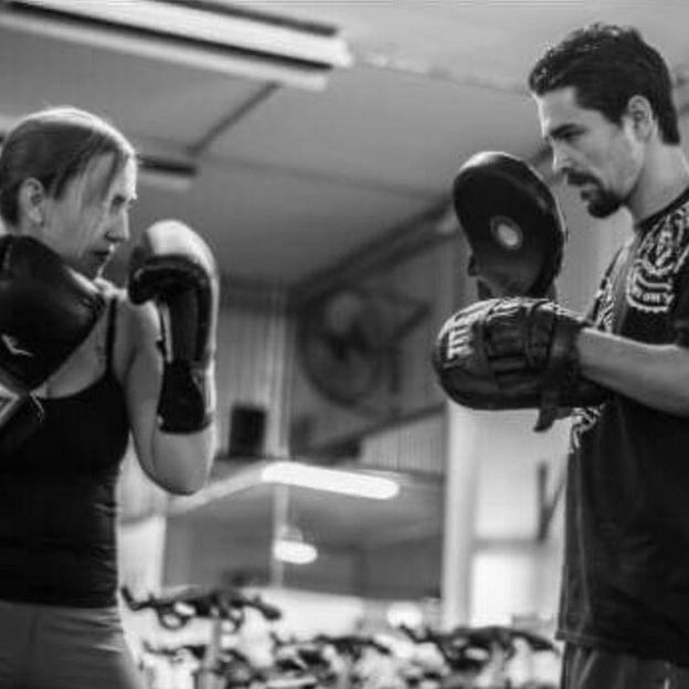 Paulie boxing client training with clients at orange county, california gym.