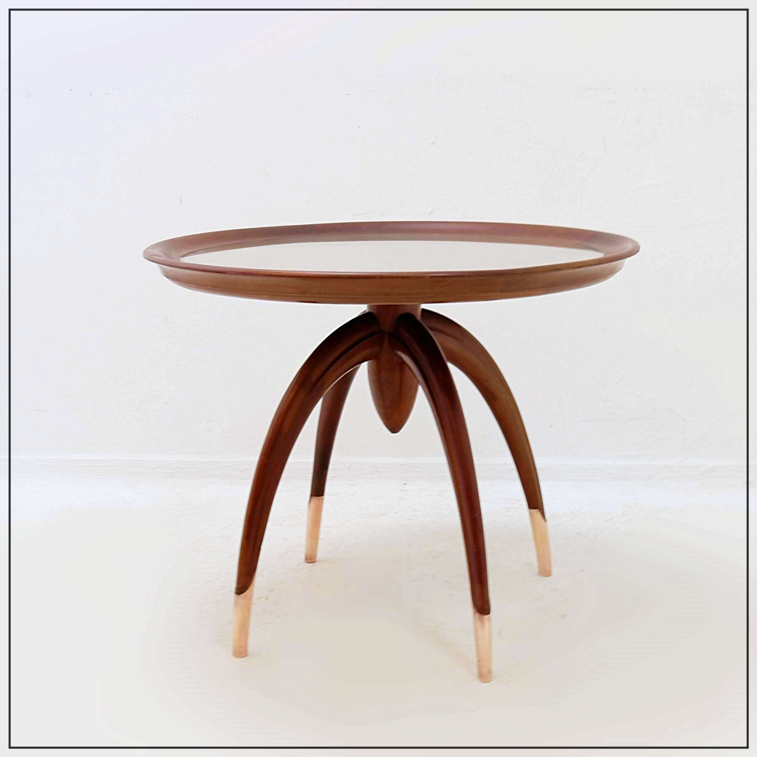 Art Deco round wooden side table with curved legs and brass feet