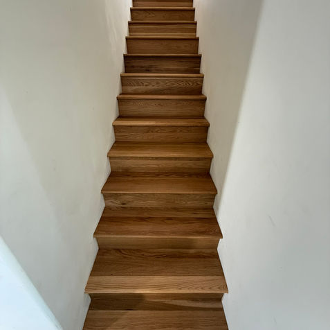 solid wood staircase with plaster walls