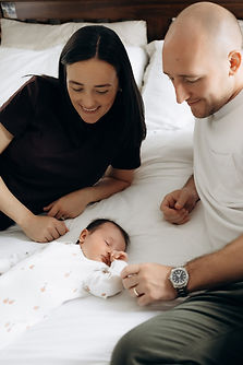 Newborn - parents on bed.jpg