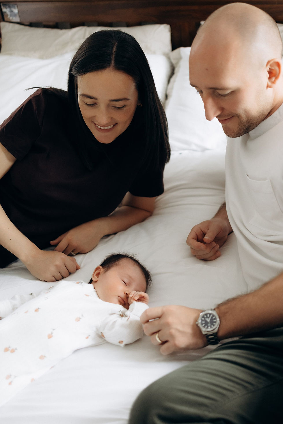 Newborn - parents on bed