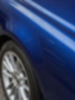 Polished blue car fender after car detailing
