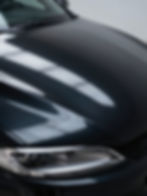 Close-up of a glossy car hood after car detailing.