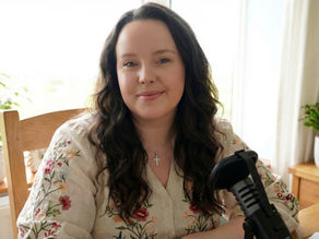 arroe sat behind podcast mic