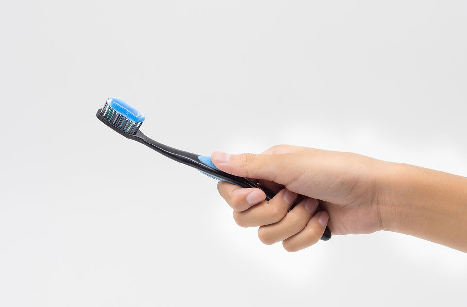 Female hand holding a Toothbrush with toothpaste isolated on white background.jpg