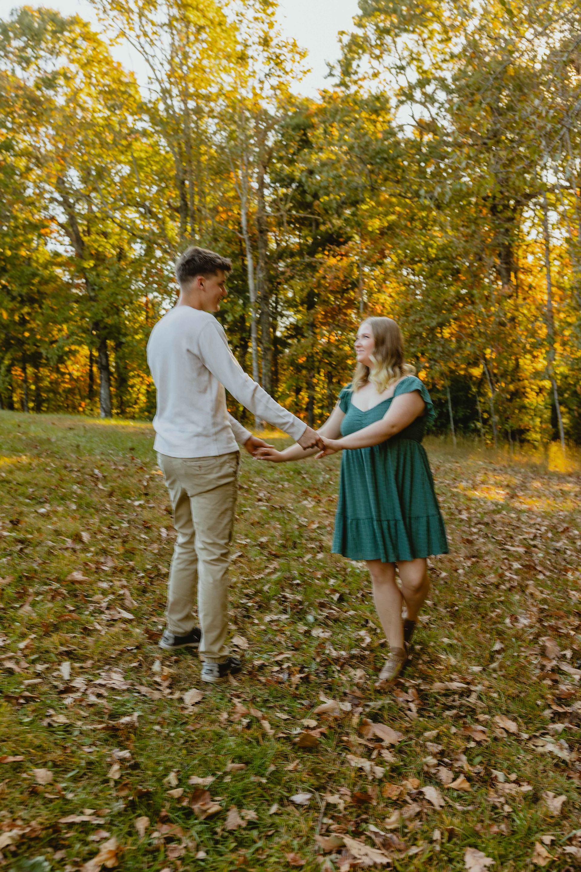 Couple is holding hands spinning around. There is a blur to show the movement.  