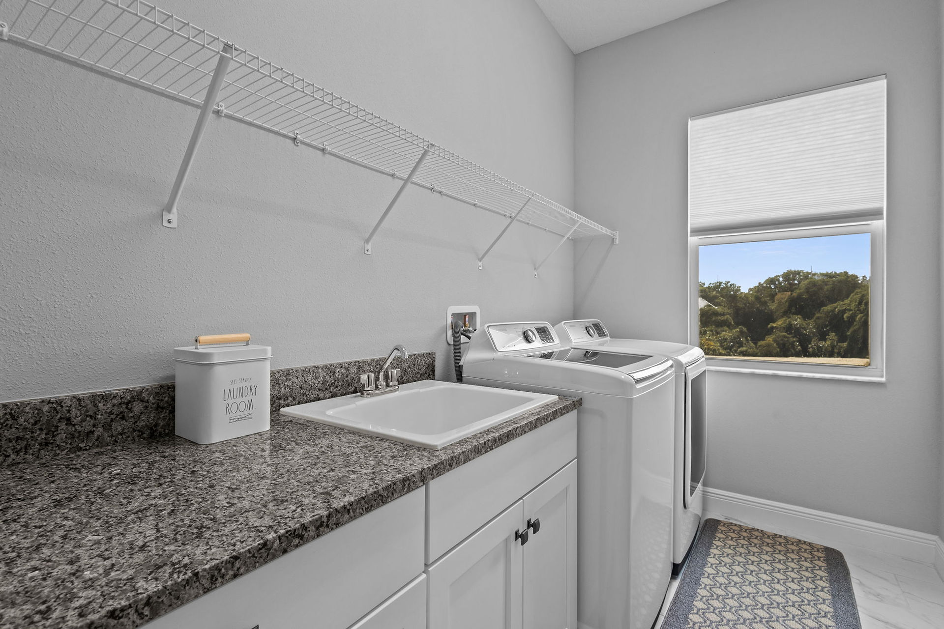 laundry room with white washer and dryer and wire shelving