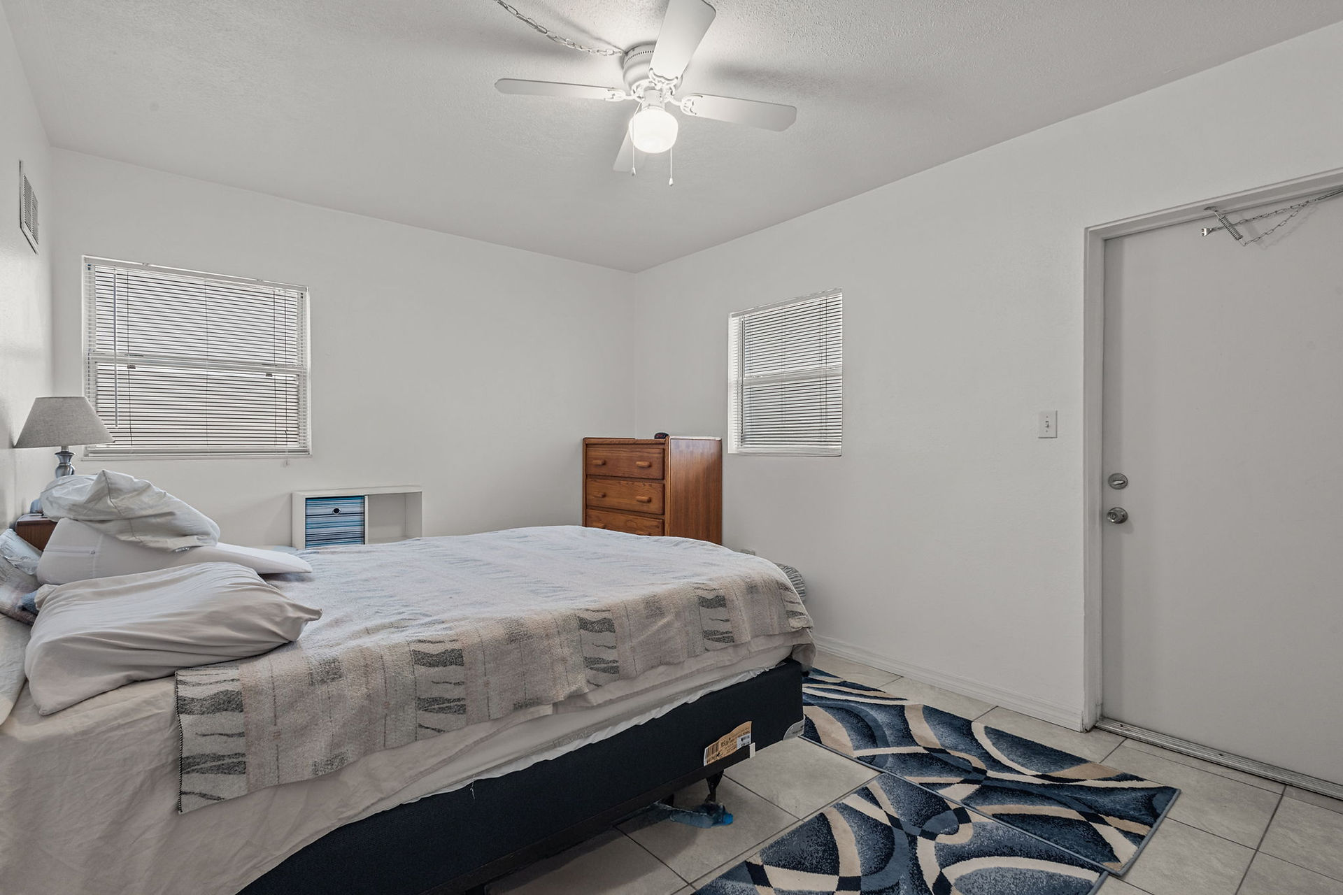 white bedroom with wooden chest