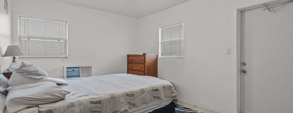 white bedroom with wooden chest
