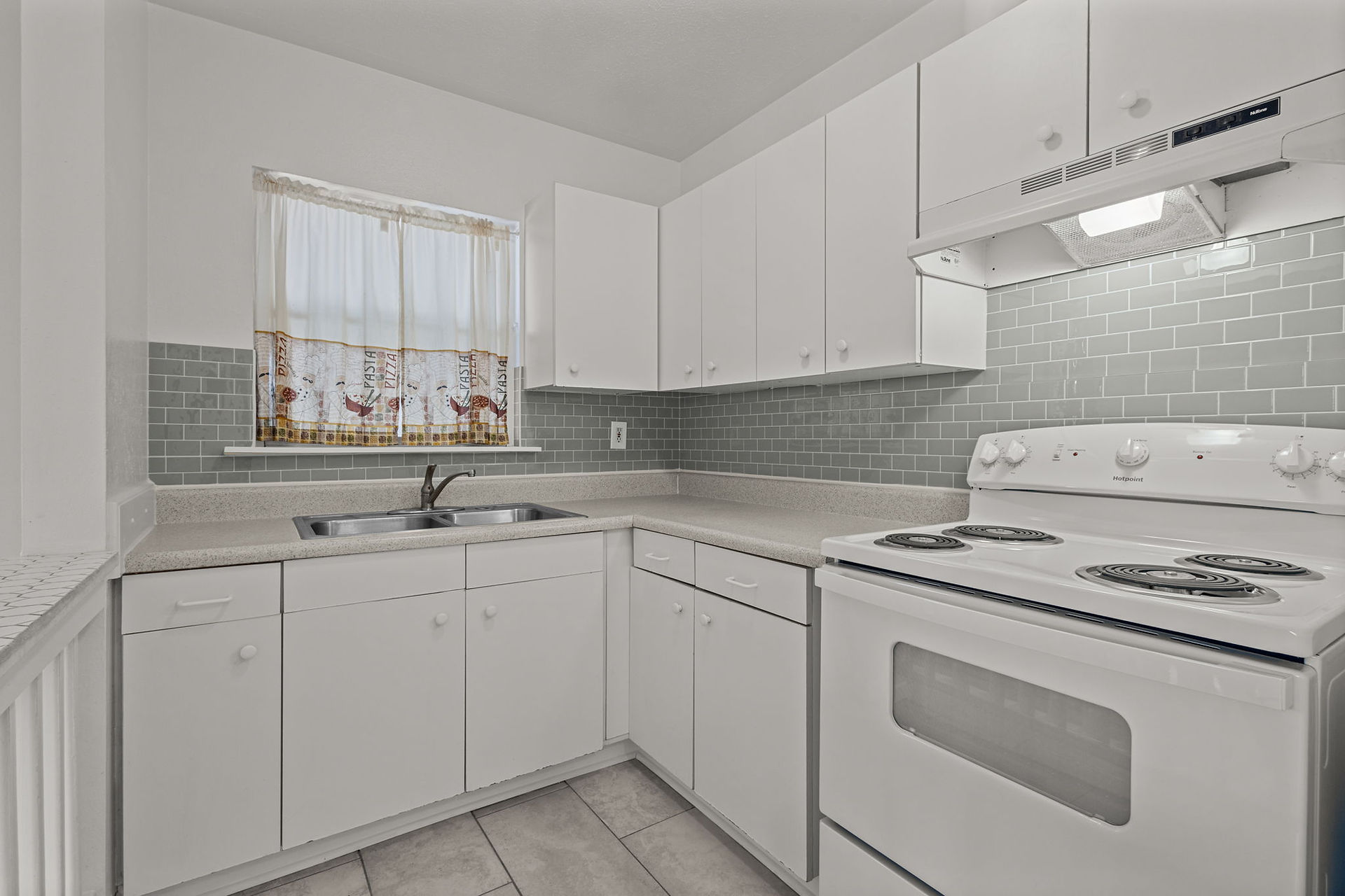 clean white kitchen with white stove