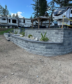 retaining wall installation with rock platform gravel and plants has retaining wall stairs multi level