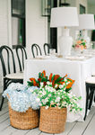 outdoor wedding reception table with colorful flowers and lamps
