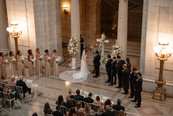 wedding ceremony with bride, groom, bridesmaids and groomsmen