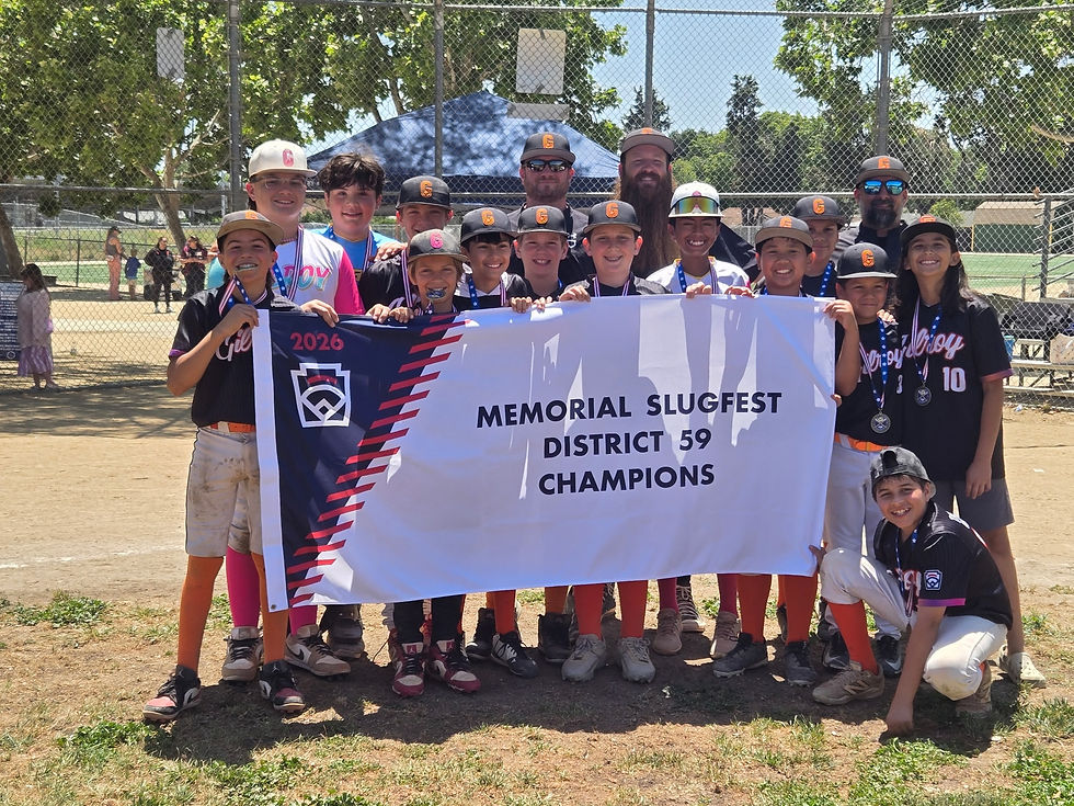 The Gilroy Giants celebrate their victory as the 2026 District 59 Slugfest Champions, proudly displaying their championship banner on the baseball field.