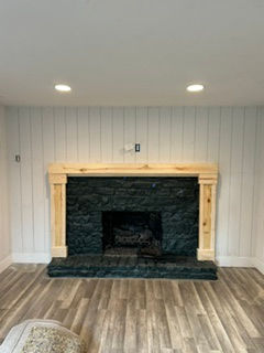 Custom fireplace mantel and columns built and painted black by TK Painting