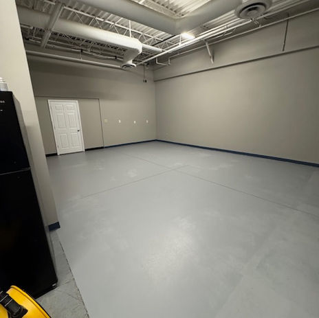Commercial interior painting with gray walls and exposed ceiling
