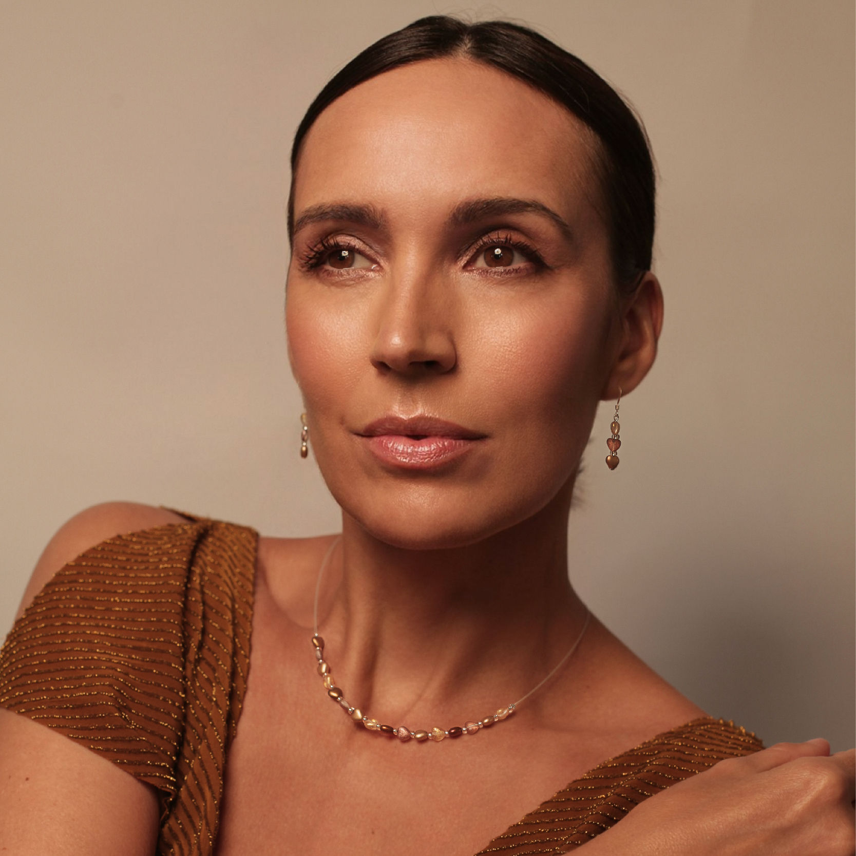 Model wearing Golden Calon Hearts Necklace, Bracelet and earrings