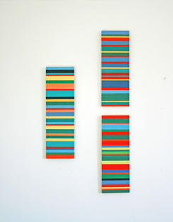 Two thin portrait rectangles with colourful bands of thread wrapped around them. By Katya Derksen.