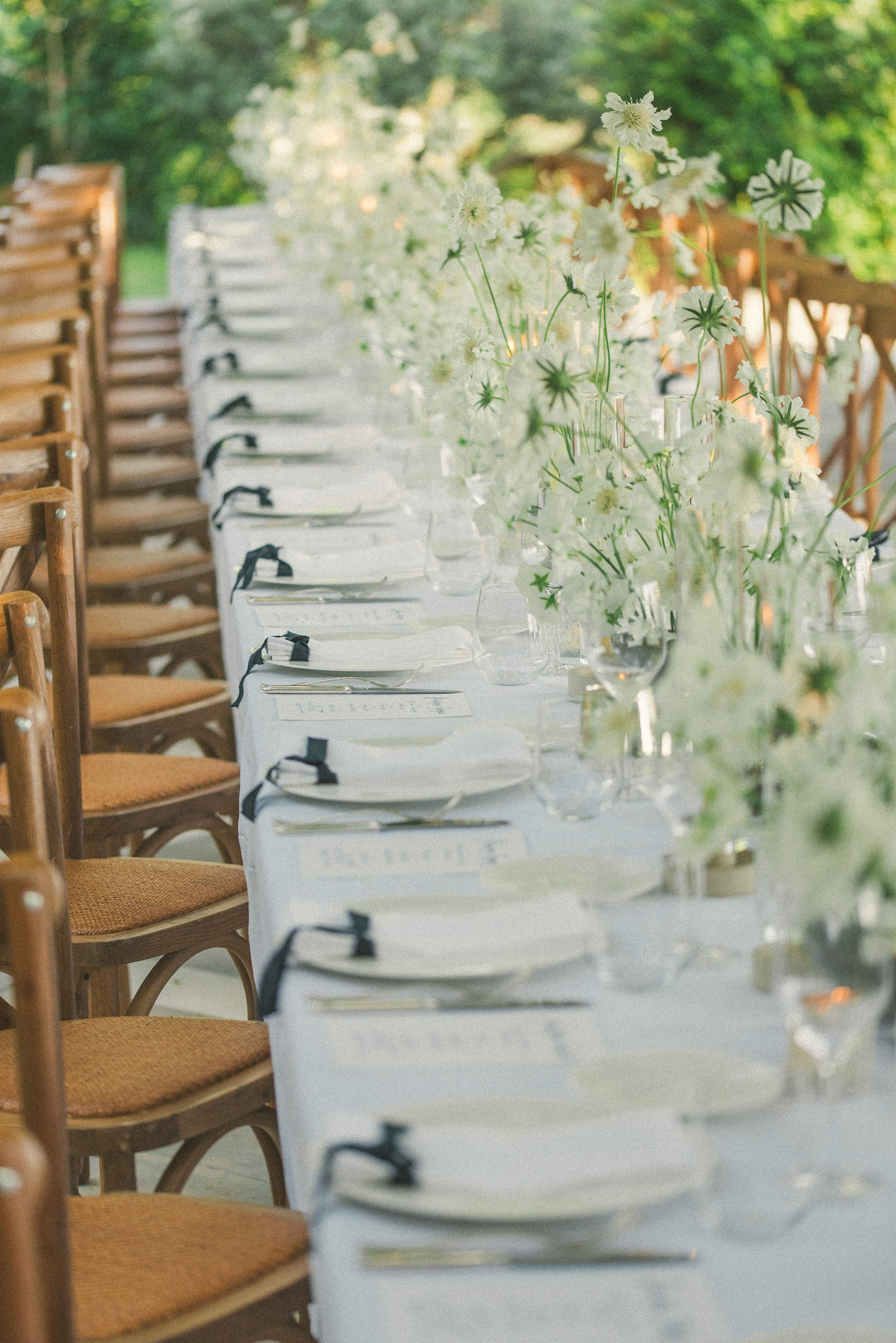 romantic wedding table setup - white flowers and wooden chairs - wedding planner all things beautiful