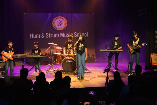 Students of Hum & Strum Music School performing live at a concert in Bangalore