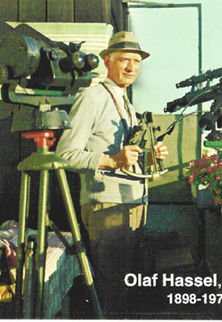 Olaf Hassel on a deck with two telescopes.