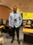 Smiling man with event badge at Safe Sport conference