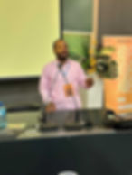 Man speaking at a podium during a presentation