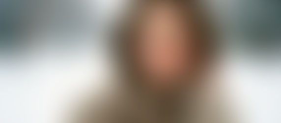 A smiling woman with glowing, hydrated skin in winter snow, representing the deep hydration effects of mesotherapy, skin boosters, hyaluronic acid injections, and dehydrated skin treatment.