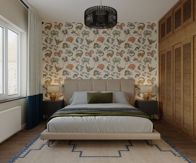 Beige upholstered bed against zodiac-print wallpaper with louvred wooden wardrobe doors
