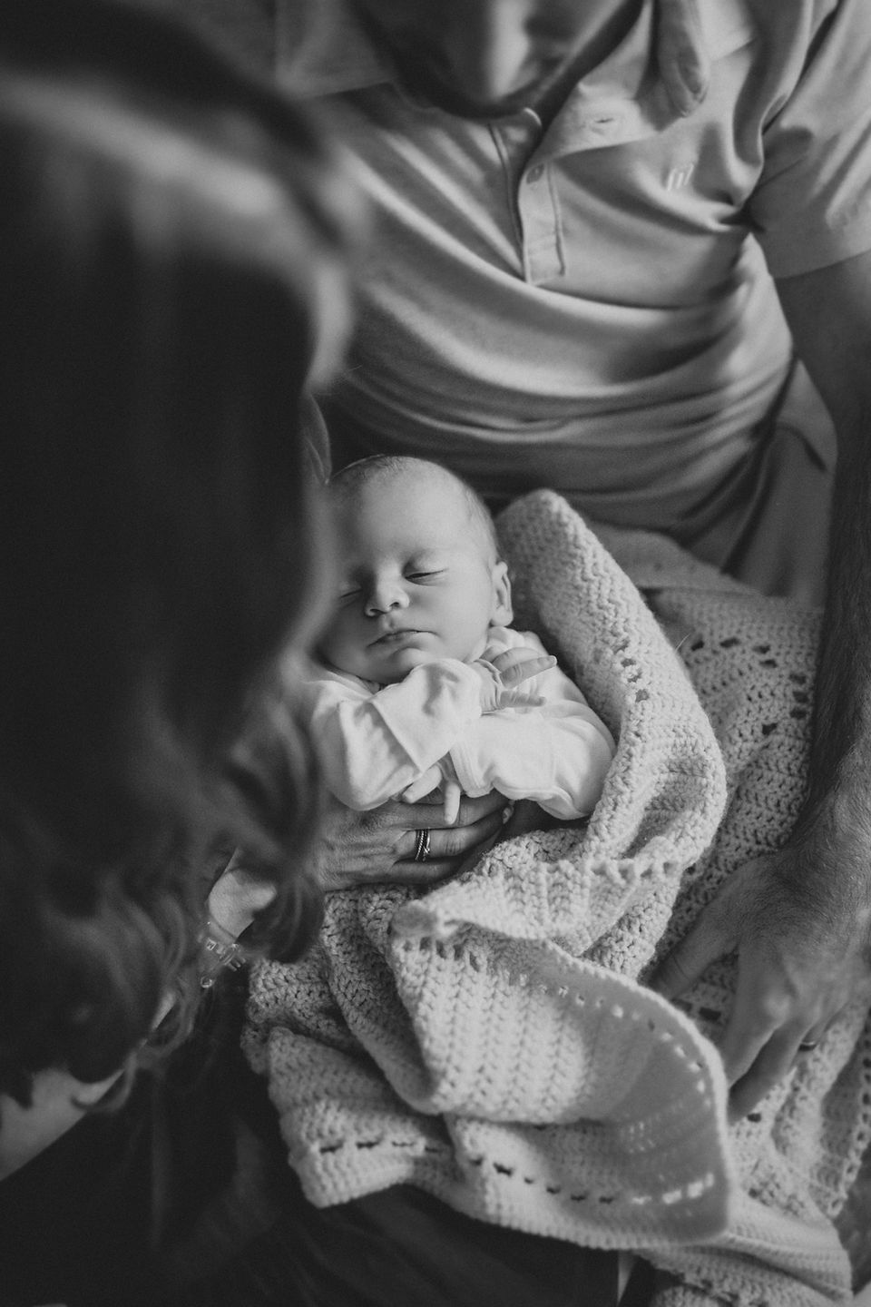 a newborn baby sleeping on his parents during his newborn lifestyle photography session in charlotte