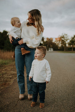 a mom walking down a road with her two young sons for family portraits in lake norman