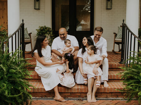a family interacting with each sitting on the front porch steps during their lake norman family photography session