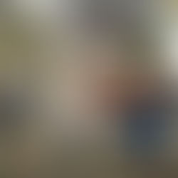 a mom kneeling down to see a rock that her young son placed in her hand at Camp North End in Charlotte NC