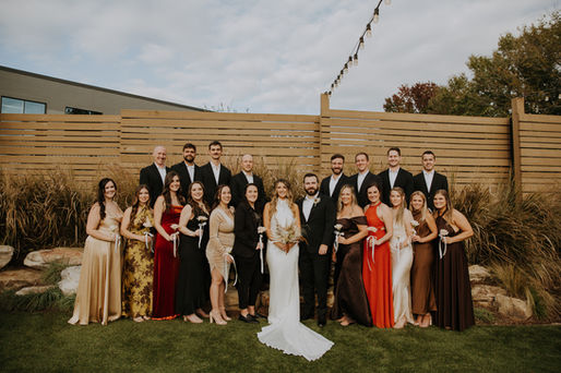 A bride and groom with their bridal party posing for their Charlotte wedding photography at The Ruth