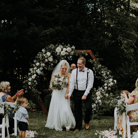 a bride and groom holding hands during their processional for their charlotte micro wedding photographer