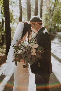 a bride and groom holding each other close in the woods of Jetton Park in Cornelius