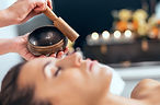Shot of beautiful young woman having reiki healing treatment in health spa center.jpg