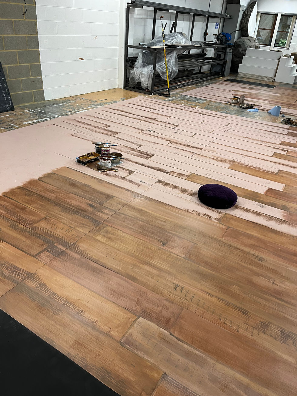 Beginning to paint the wooden planks for the floor