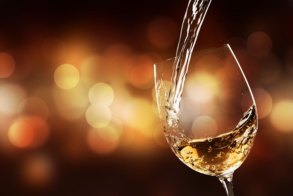 White wine being poured in the wineglass_edited.jpg