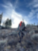 hunter hiking out with an elk on his backpack