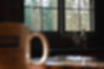 coffe mug on the table with morning light spilling through the lodge window