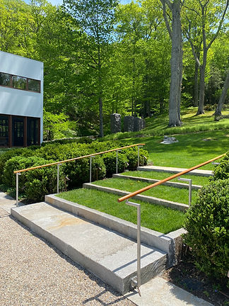 A wide shot of backyard stairs with bespoke railings.