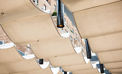 A close up view of cable purlins with fabric panels hanging from them.