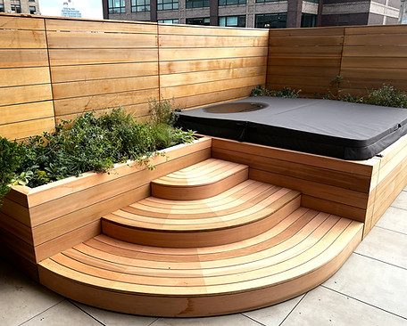 Wood clad hot tub, deck, stairs, and planters